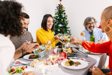 Happy multi generational family enjoying christmas dinner at homeの写真素材