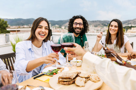 Happy group of friends enjoying dinner barbecue in summer at home terrace.の写真素材