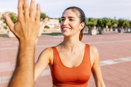 Young fitness woman doing high five for sport motivation or successの写真素材
