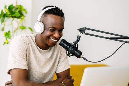 Young african content creator man streaming live podcast from home studioの写真素材