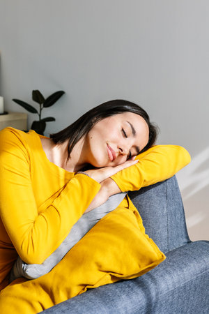 Young beautiful woman relaxing on sofa at home.