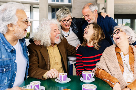 Joyful group of senior friends having fun drinking coffee at cafeteria barの写真素材