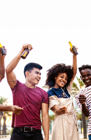 Group of multiracial young friends having fun on summer partyの写真素材