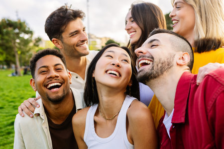 Diverse group of young friends having fun together outdoors in summer