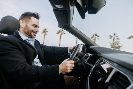 Successful mid adult businessman driving cabriolet carの写真素材