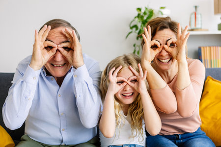 Portrait of happy multi-generational family having fun doing funny faces