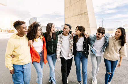 Multiracial group of young friends walking together outdoorsの写真素材