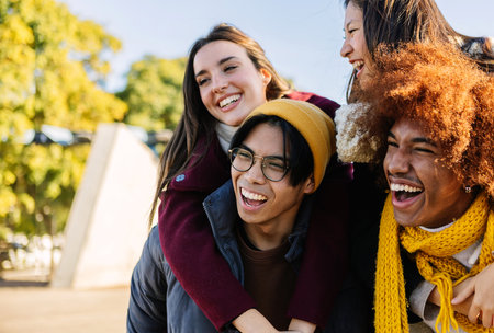 Young group of multiracial friends having fun together on winter vacation