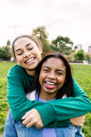 Vertical portrait of two diverse best friends womanの写真素材