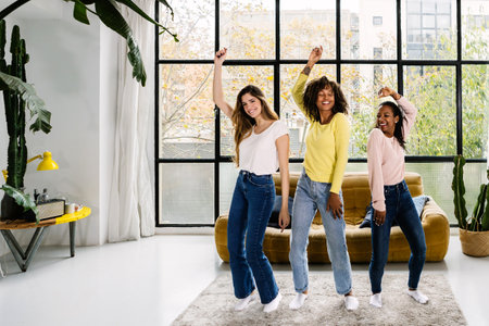 Three multiracial young women friends having party at home