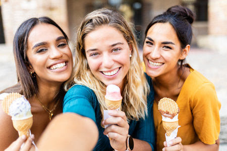 Friends taking selfie together while eating ice cream