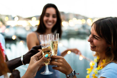 Summer lifestyle concept with young multiracial people cheering on boat partyの写真素材