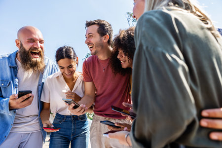 Portrait of hipster young friends using their mobile phone togetherの写真素材