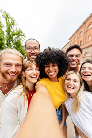 Young millennial people taking selfie portrait with phone at city street.の写真素材
