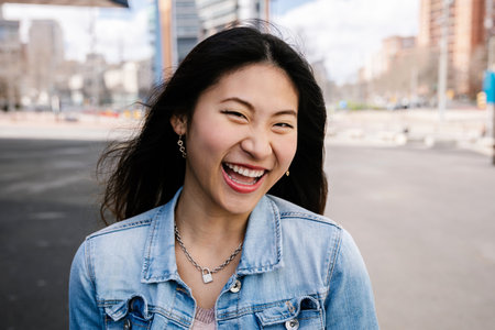 Young cheerful asian girl smiling at cameraの写真素材