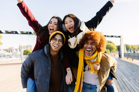 Portrait of diverse young group of friends having fun together outdoor on winter