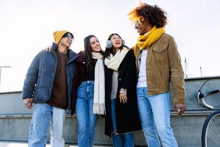 Happy multi-ethnic friends laughing together on winter dayの写真素材