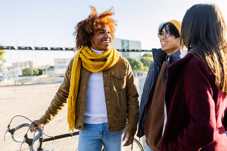 Young diverse group of friends bonding together on winter at city street