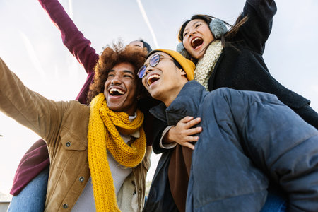 Happy diverse group of friends having fun together on winter seasonの写真素材