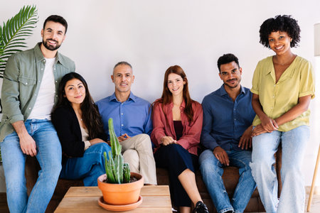 Diverse group of successful business team sitting together at coworking officeの写真素材