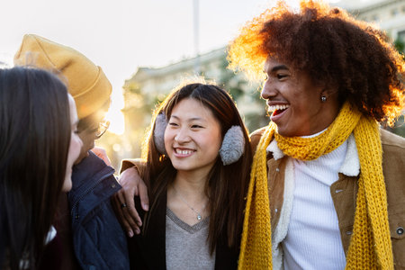 Diverse group of young friends having fun together outdoors on winterの写真素材