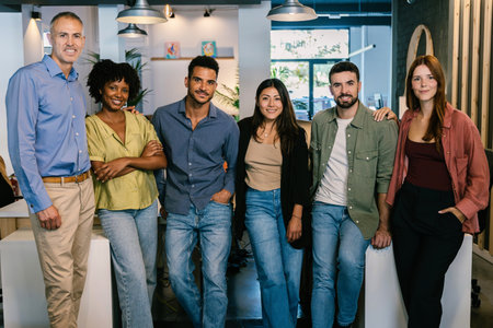 Diverse group of successful business team standing together at modern officeの写真素材