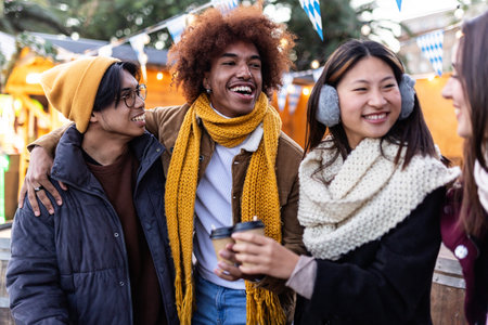 Young group of diverse people in winter clothes having fun on christmas vacation