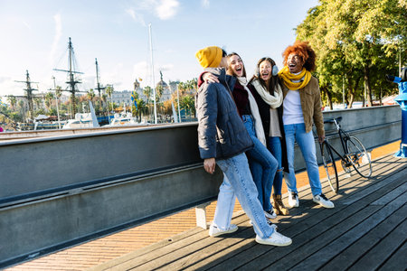 Diverse group of friends talking at city street on winter