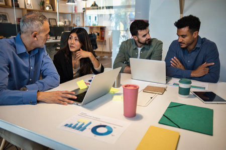Team meeting in modern office with coworkers discussing project ideas