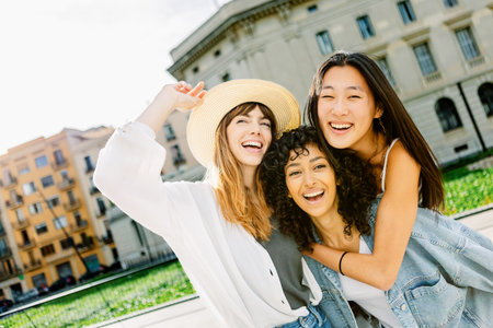 Diverse group of young women smiling outdoors in the cityの写真素材