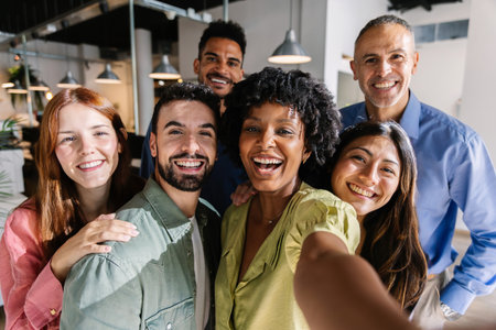 Diverse group of business coworkers taking selfie at the officeの写真素材