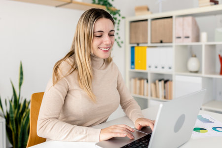 Young adult caucasian businesswoman working on laptop at home officeの写真素材
