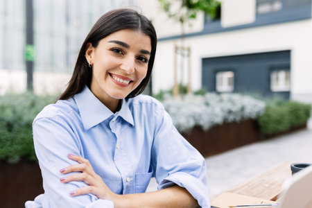 Professional business woman smile at camera sitting outdoors.の写真素材