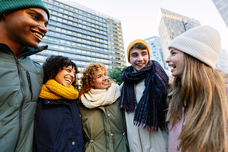 Young friends exploring city streets on a sunny winter dayの写真素材