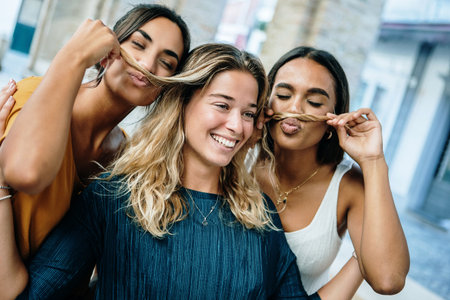 Three young women having fun taking photo together on summer vacation