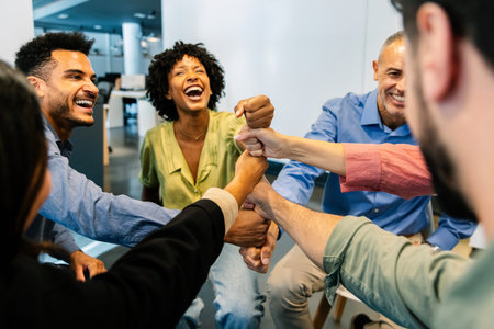 Business team celebrating success with raised fistsの写真素材