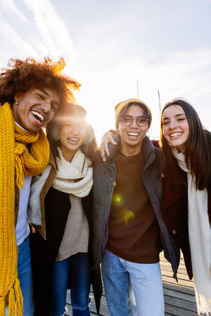 Happy multi-ethnic friends enjoying winter holidays together