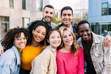 Portrait of young group of diverse people smiling at camera standing outdoorの写真素材