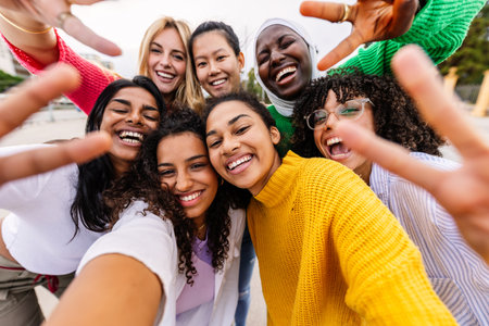 Multiracial young group of women having fun together taking selfie portraitの写真素材