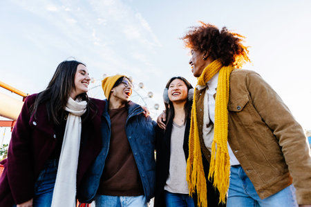 Diverse group of young friends having fun together outdoors on winterの写真素材