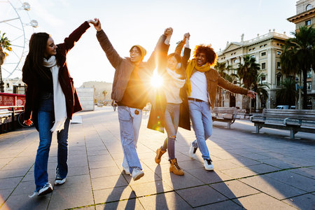Happy group of young people having fun together walking in Barcelonaの写真素材