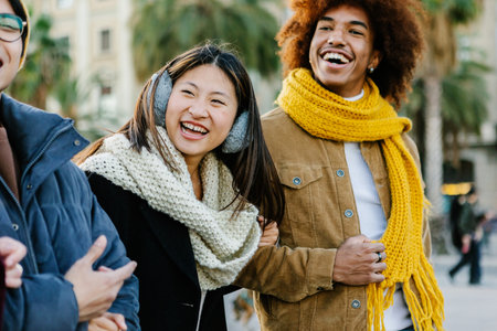Happy friends walking and having fun together in winterの写真素材