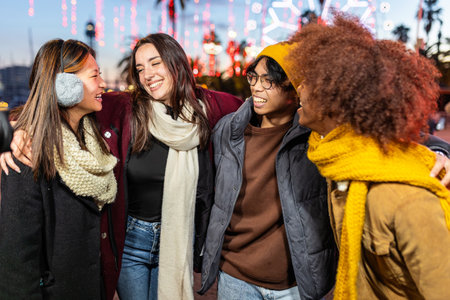 Multiracial group of young people having fun on winter standing outdoorsの写真素材