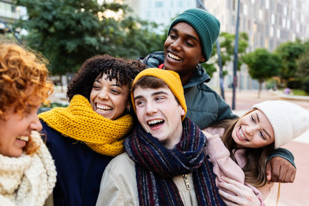 Diverse young group of millennial friends having fun together on winter