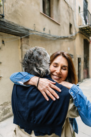 Senior adult couple embracing with love in barcelona streetの写真素材