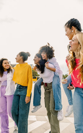 Group of women laughing outdoors showing unity and warmth