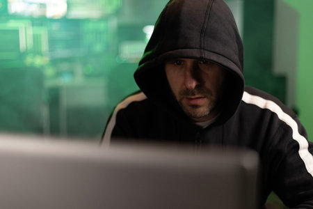 Hacker breaking into a secure network in a dark room
