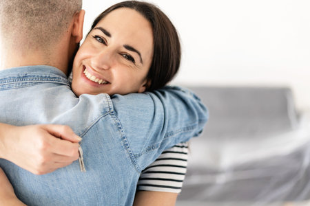 Happy young lovely couple moving in their new apartment