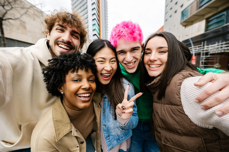 Young diverse friends taking group selfie on streetの写真素材