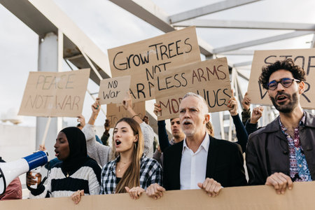 Diverse protesters chanting slogans during anti-war demonstrationの写真素材